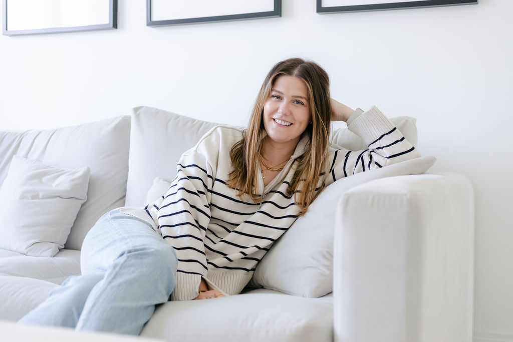 CBT therapist Natalie Englander reclining on white sofa