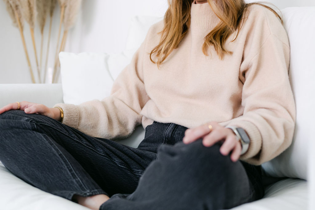 Natalie sitting cross-legged on sofa practicing mindfulness for burnout 